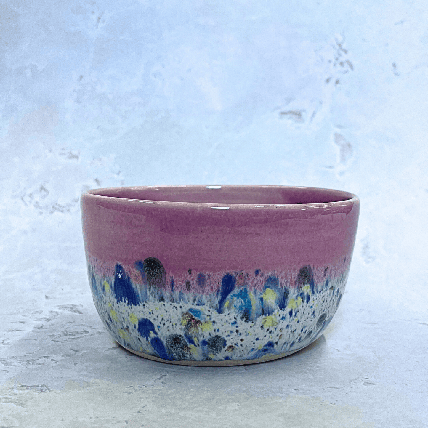 Ella Fletcher Designs UK Handmade Ceramic Small Bowl in Pink Shoreline design, round bowl with pink and multicolour speckles, side view