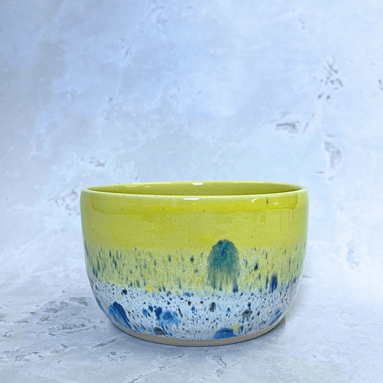 Ella Fletcher Designs Handmade Ceramic Small Bowl in Yellow Shoreline design, round bowl in yellow with multicolour speckles, side view