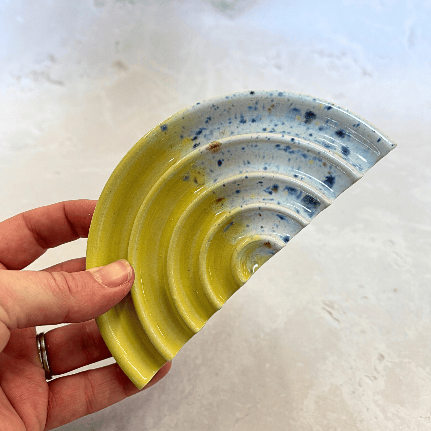 Ella Fletcher Designs Handmade Ceramic Soap Dish in Yellow Shoreline design, semi-circle with grooved edges, half yellow and half multi-coloured speckles