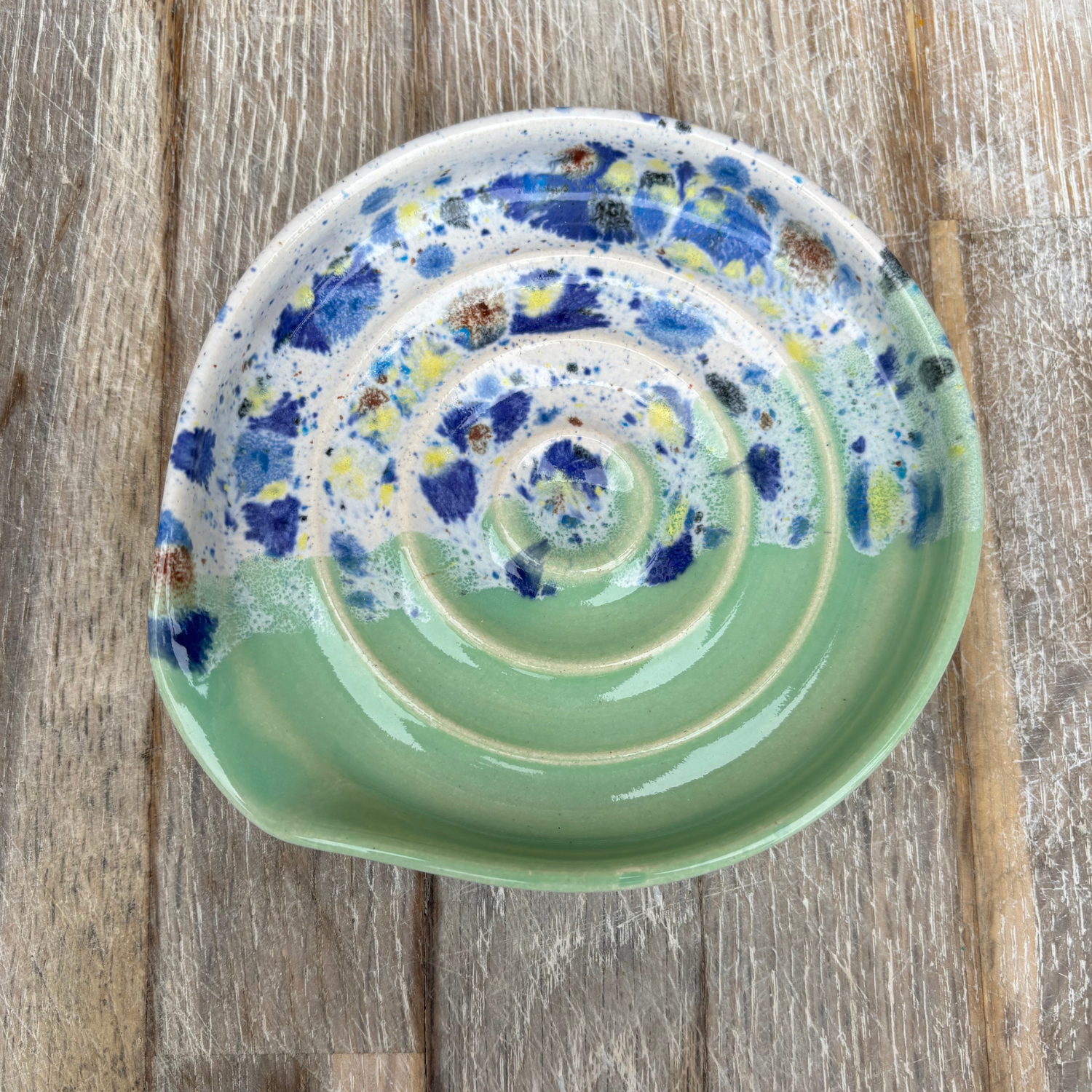 Ceramic plate with spiral design on a wooden surface