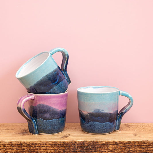 Ella Fletcher Designs Handmade Ceramics Standard Mug in Scottish Landscape Designs, ceramic mugs featuring layers of blues and pinks resembling the Scottish landscape