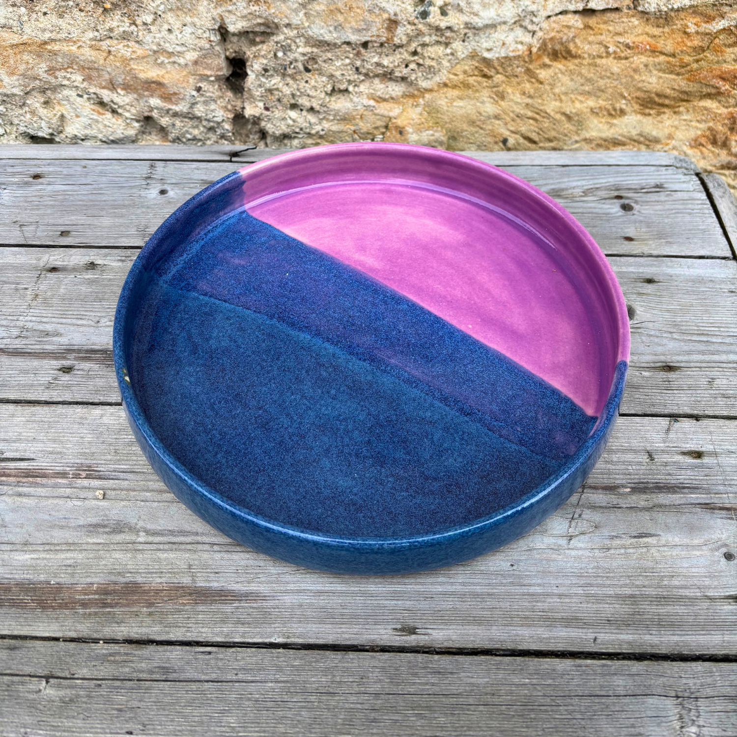 Ceramic tray with blue and pink gradient on a wooden surface