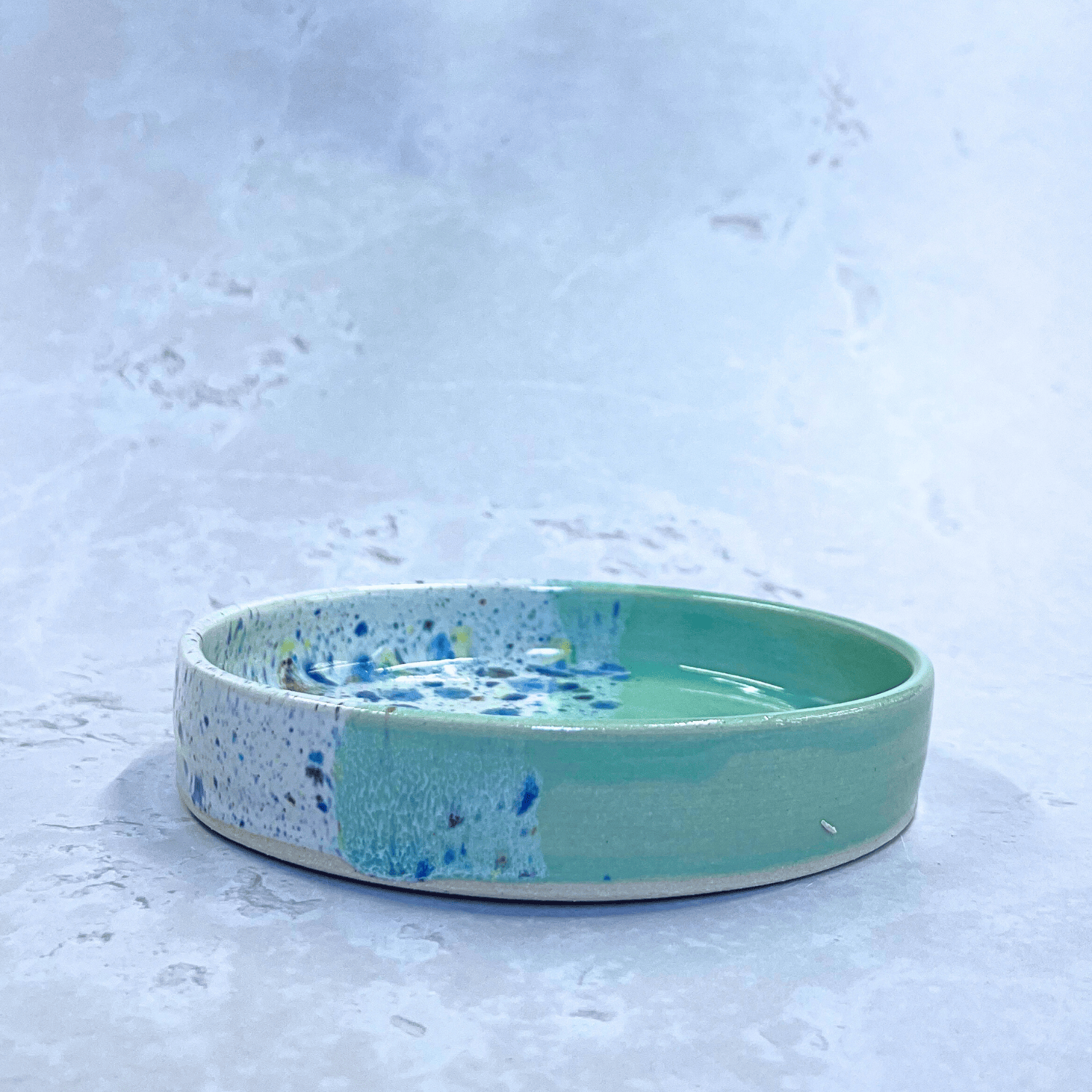 Ella Fletcher Designs Handmade Ceramics Trinket Dish in Green Shoreline Design, side view of small round green and multicolour speckled dish