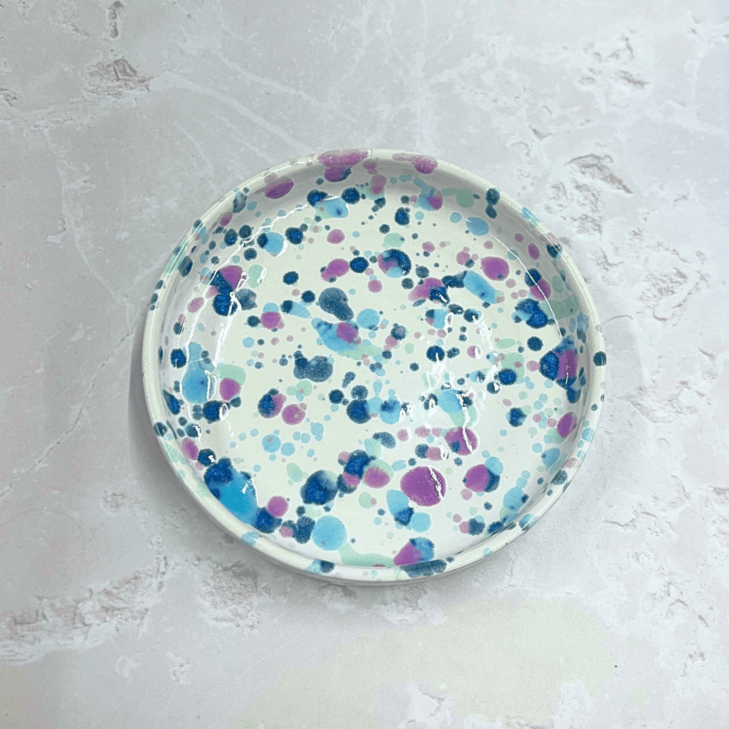 Ella Fletcher Designs Handmade Ceramics Trinket Dish in Sweetpea Design, white background with speckles of blues and pink to resemble sweet pea flowers