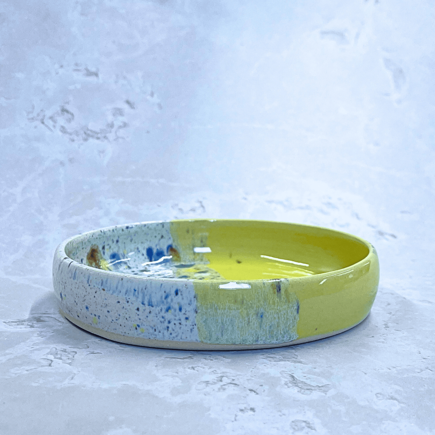 Ella Fletcher Designs Handmade Ceramics Trinket Dish in Yellow Shoreline Design, side view of small round yellow and multicolour speckled dish