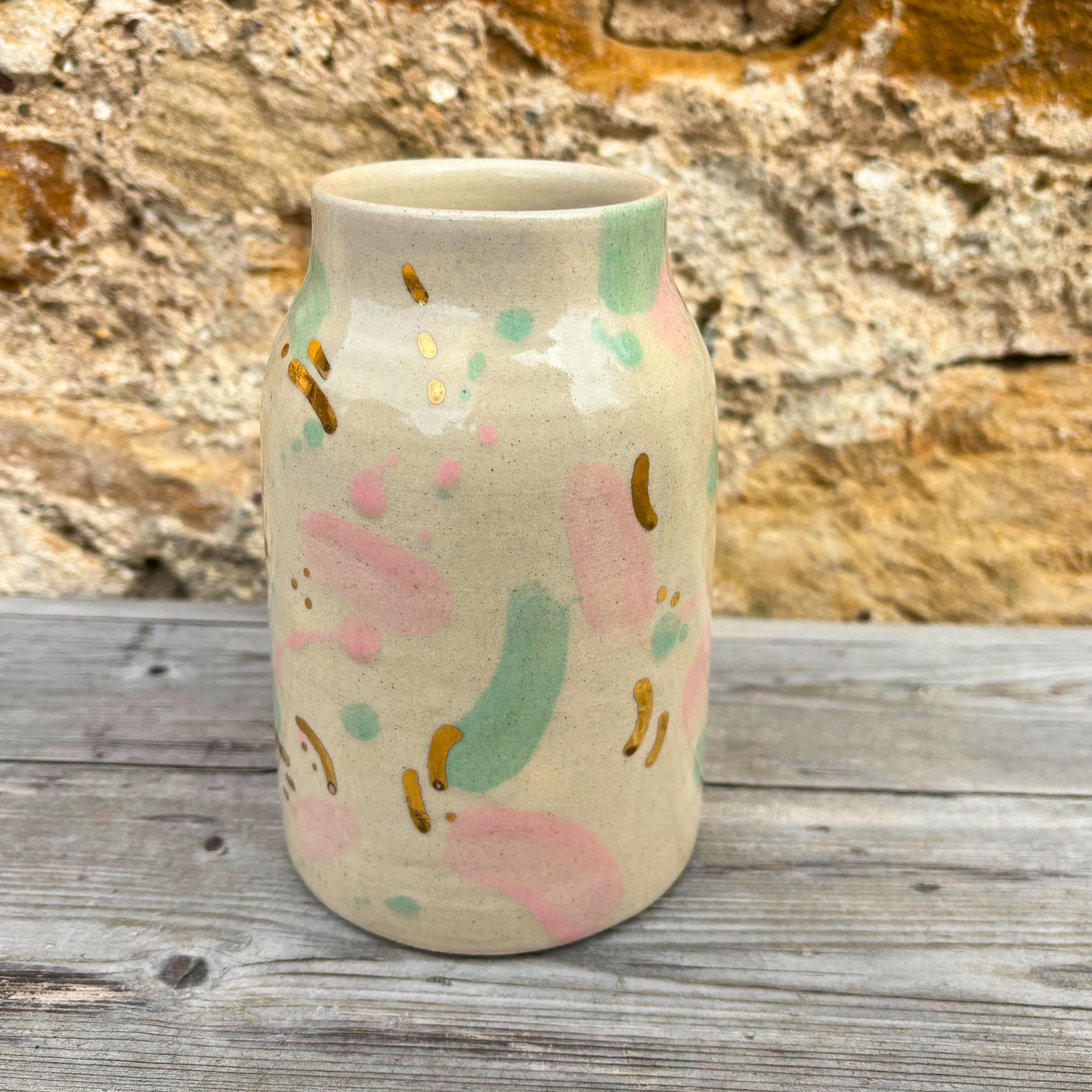 Ceramic vase with abstract patterns on a wooden surface