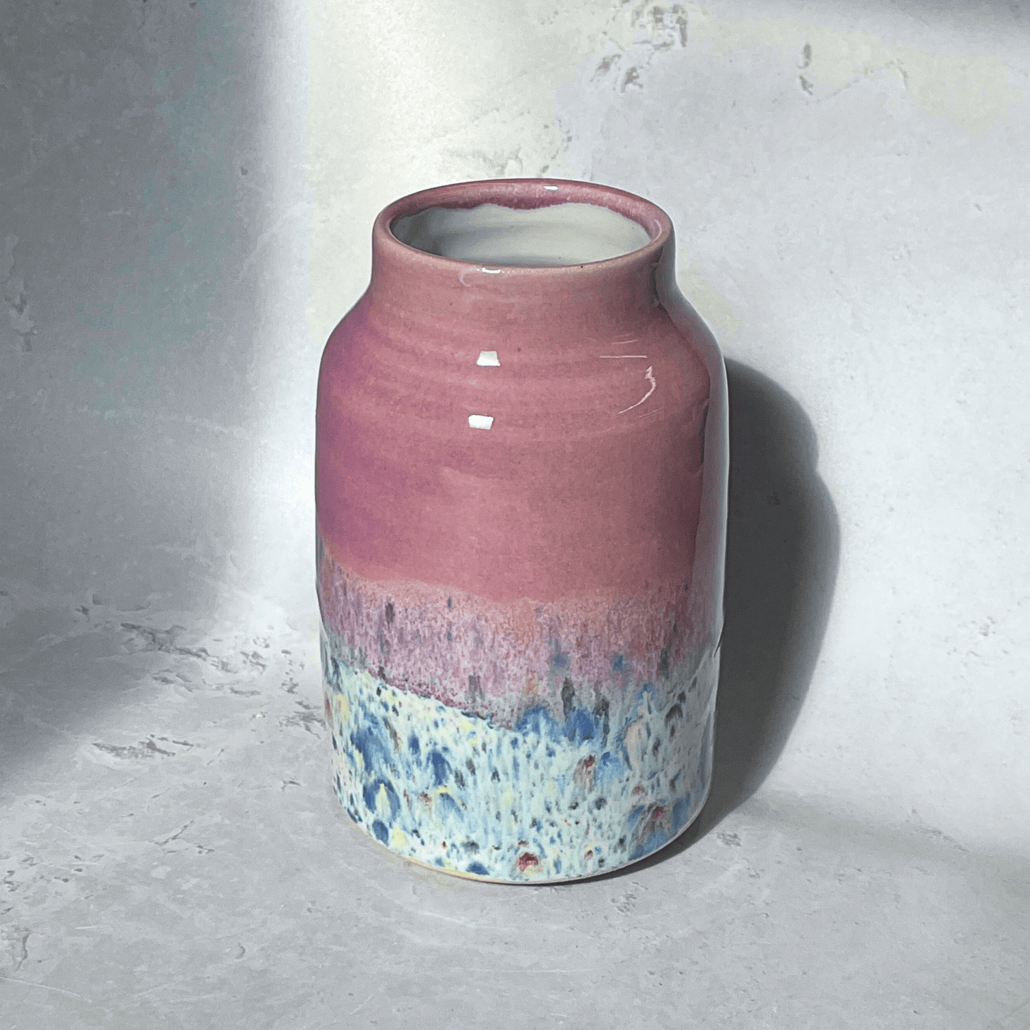 Ella Fletcher Designs Handmade Ceramic Vase in Pink Shoreline Design - vase with solid pink top and multi-coloured speckles at the bottom