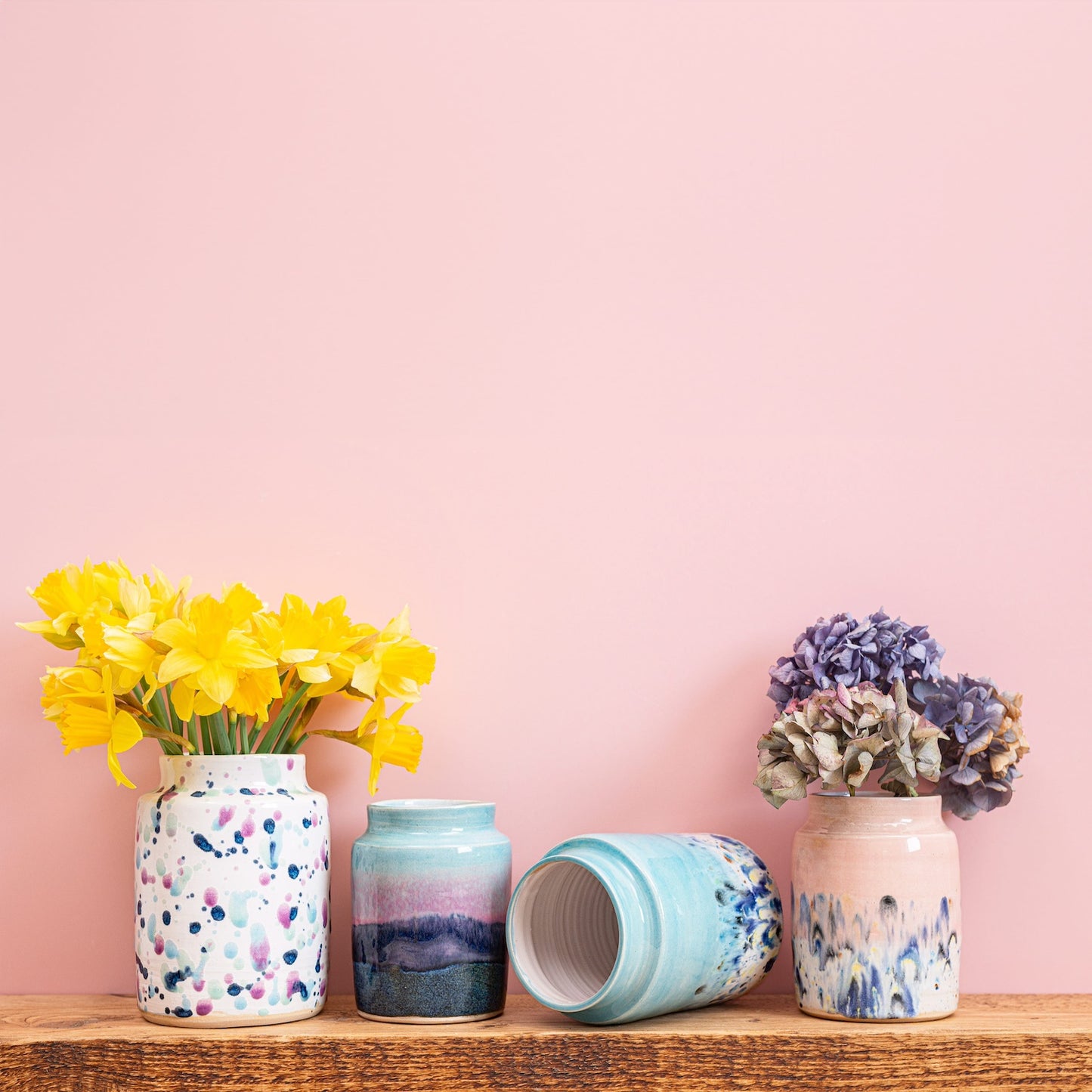 Ella Fletcher Designs Handmade Ceramic Vases in a range of sizes and designs (from left to right), Sweetpea, Scottish Sunrise Landscape, Blue & Pink Shoreline