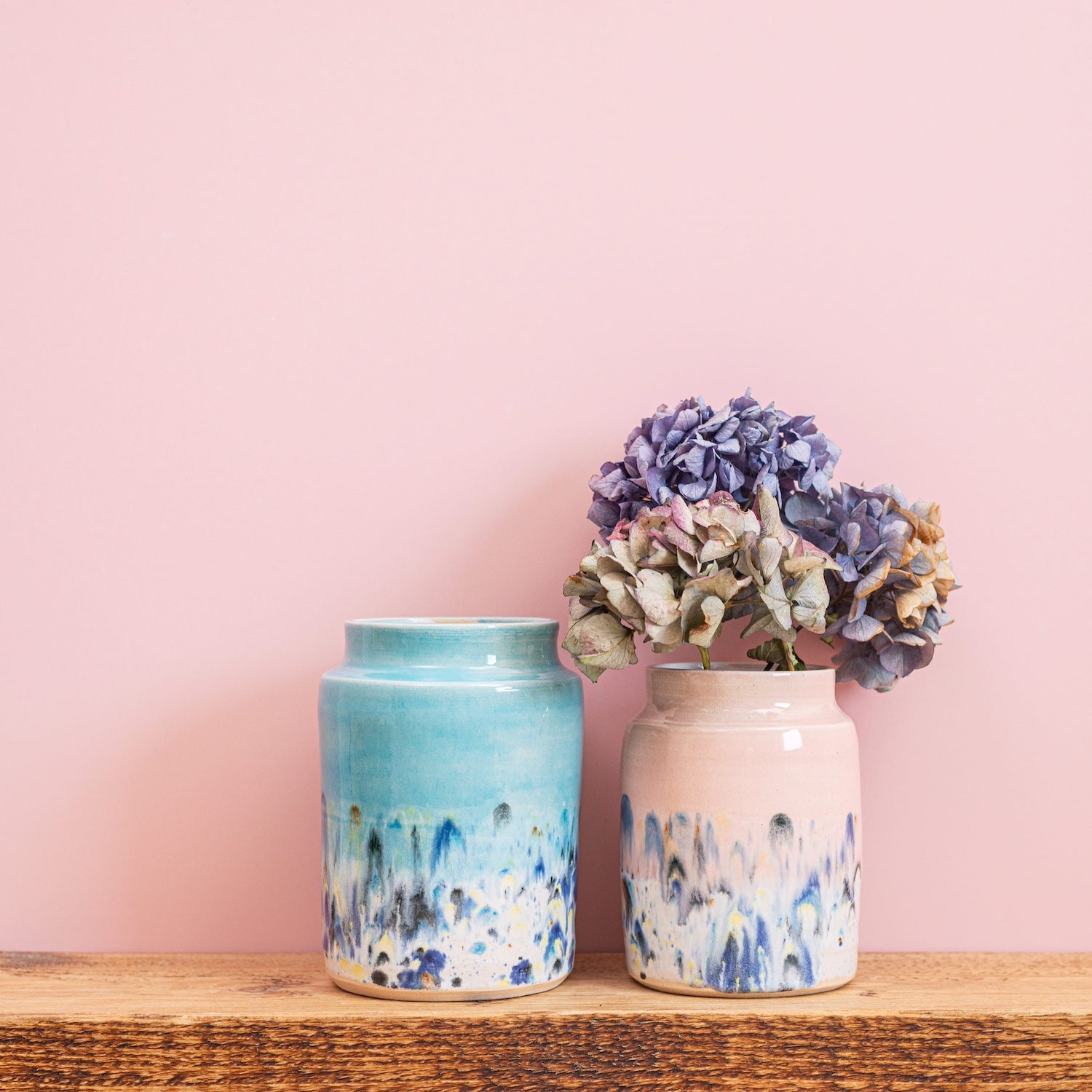 Ella Fletcher Designs Handmade Ceramic Vases, two vases in Shoreline Design, large blue vase with multicoloured speckles and medium pink vase with multicoloured speckles
