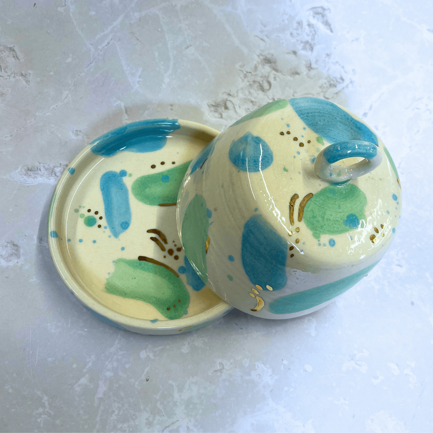 Ella Fletcher Designs Handmade Ceramic Butter Dish in Green & Blue Sea Glass, domed lid and dish with blobs of green and blue with gold speckle