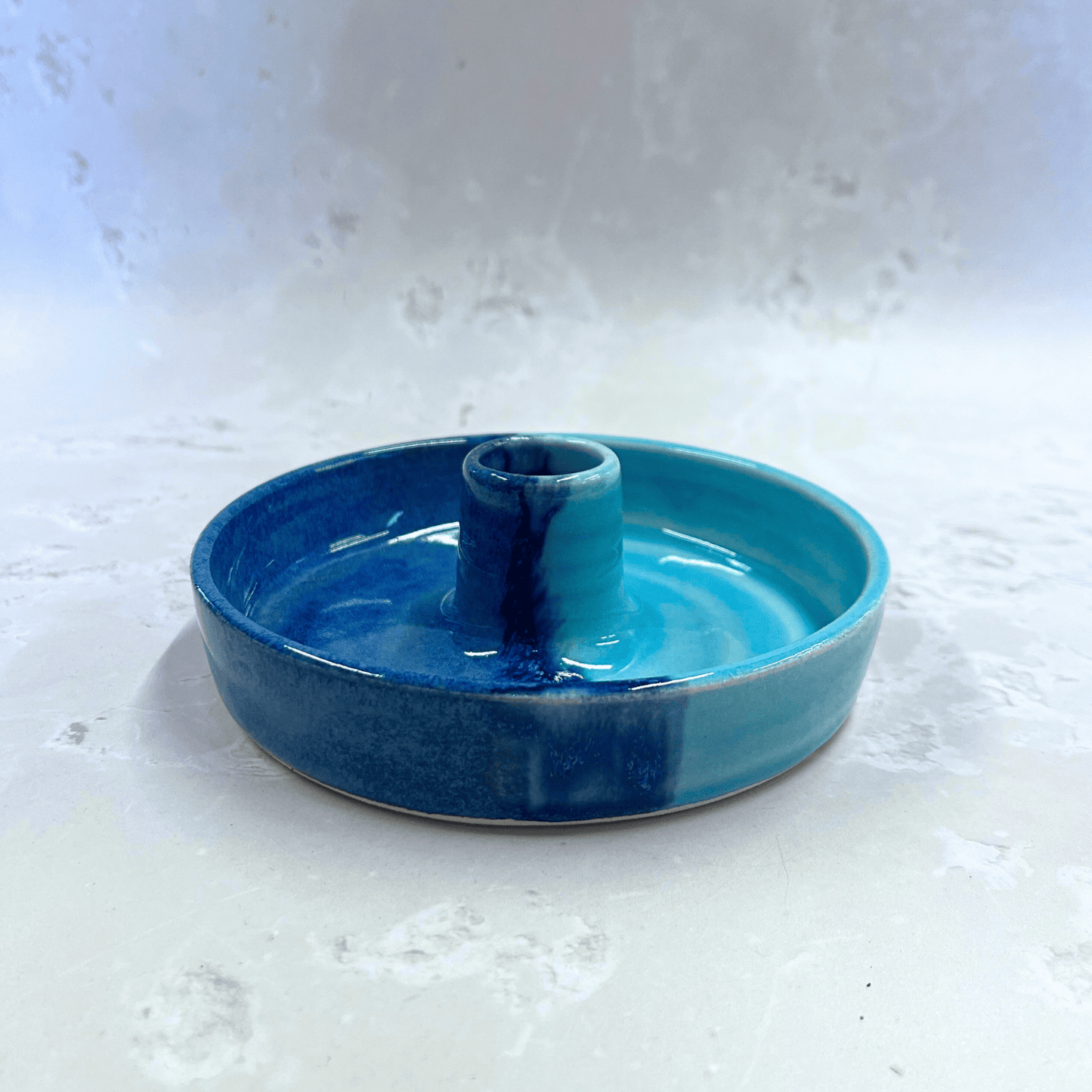 Ella Fletcher Designs Handmade Ceramic Candlestick holder in Blue Scottish Landscape design, circular candlestick holder with layered dark and light blues 
