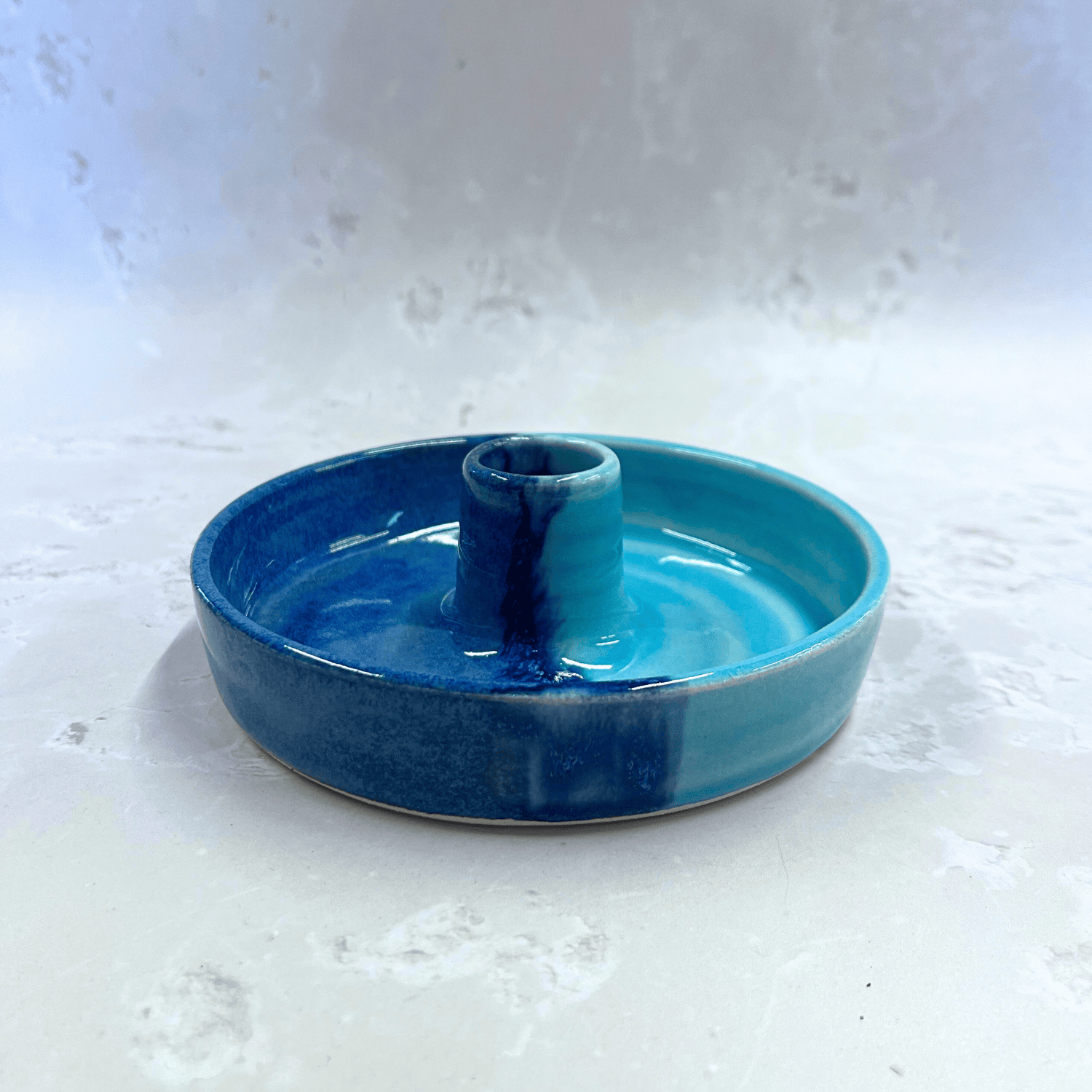 Ella Fletcher Designs Handmade Ceramic Candlestick holder in Blue Scottish Landscape design, circular candlestick holder with layered dark and light blues 