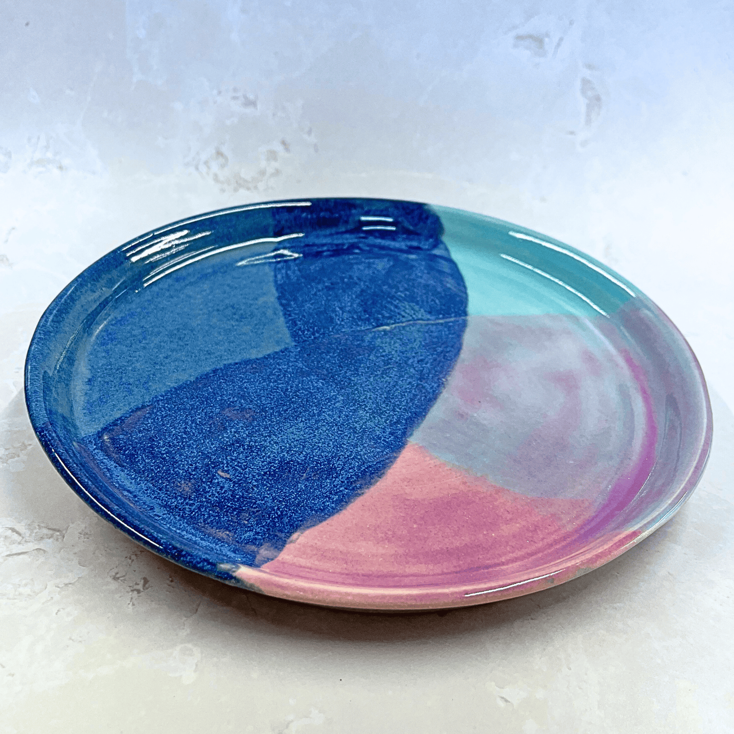 Ella Fletcher Designs Handmade Ceramic Dinner Plate in Scottish Sunrise Landscape, circular plate with layers of pinks and blues inspired by Scottish Sunrises