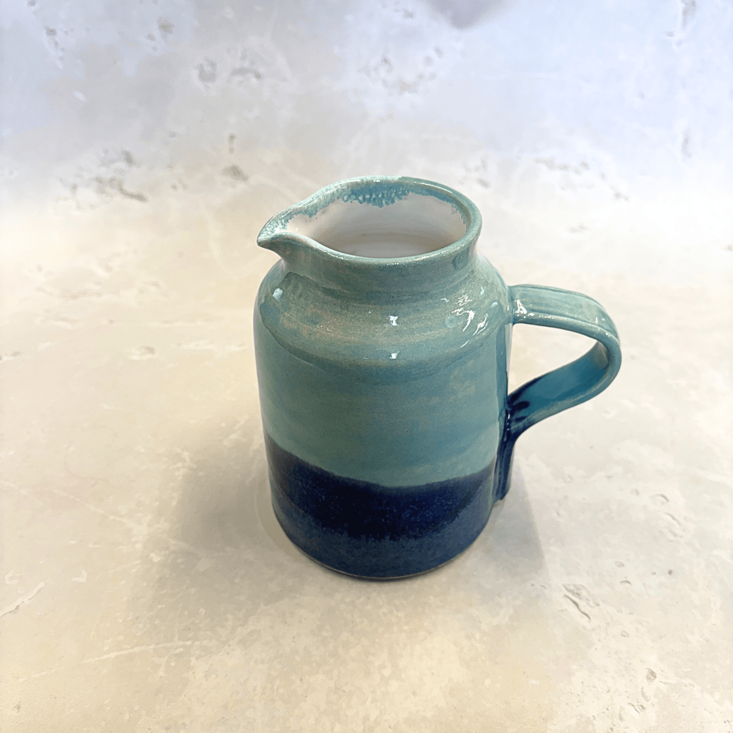 Ella Fletcher Designs Handmade Ceramic Jug in Blue Landscape, hand-thrown mug with layers of light and dark blues