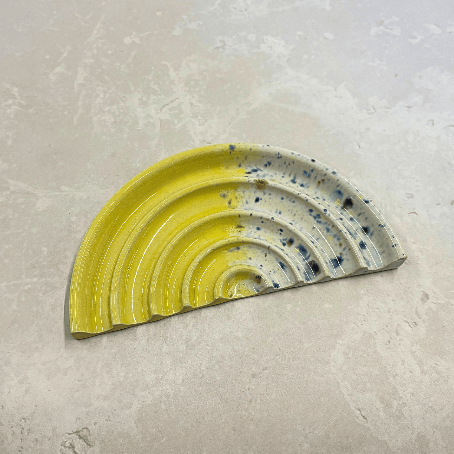 Ella Fletcher Designs Handmade UK Ceramic Soap Dish in Yellow Shoreline design, semi-circle with grooved edges, half yellow and half multi-coloured speckles