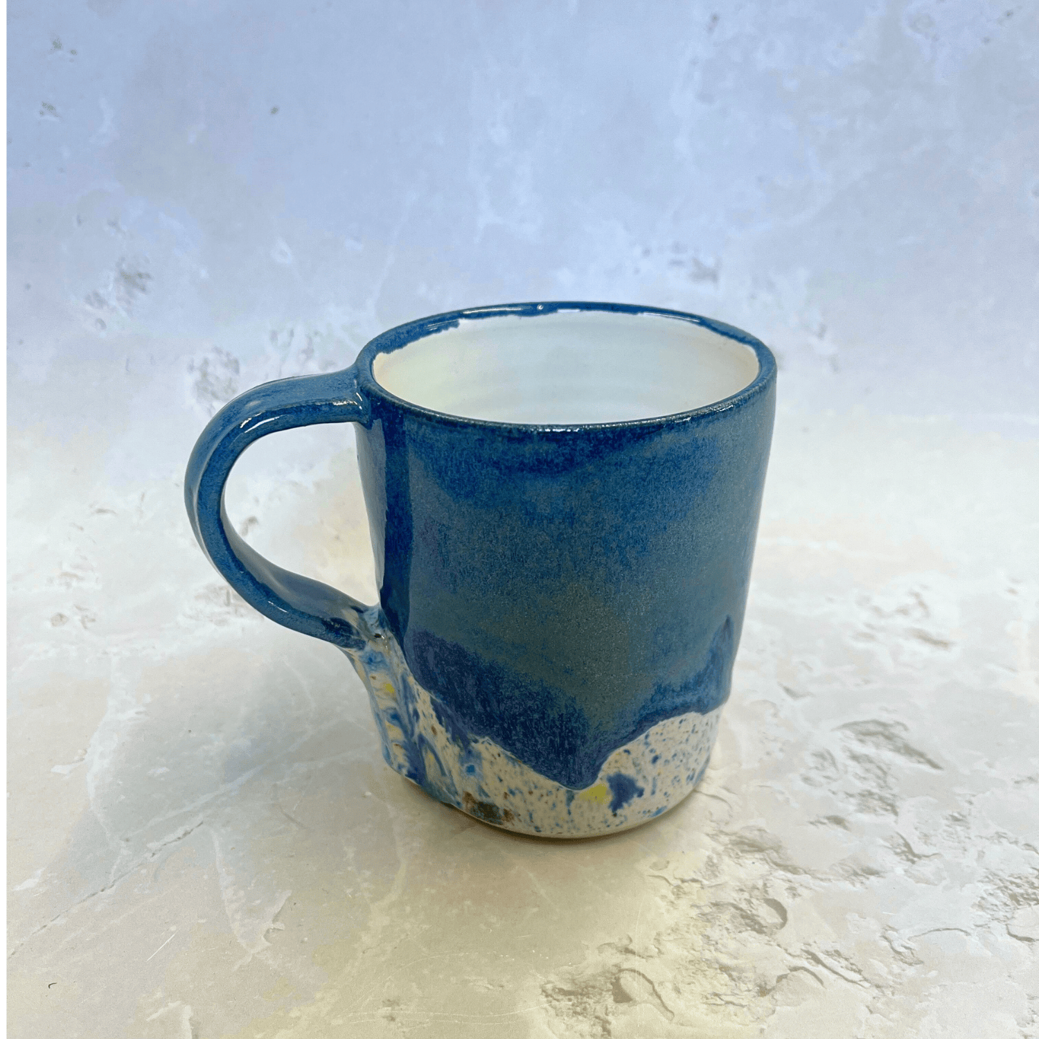 Ella Fletcher Designs Handmade Ceramic Mug in Navy Blue Shoreline Design, navy top half of mug with a speckled bottom half inspired by East Lothian beaches
