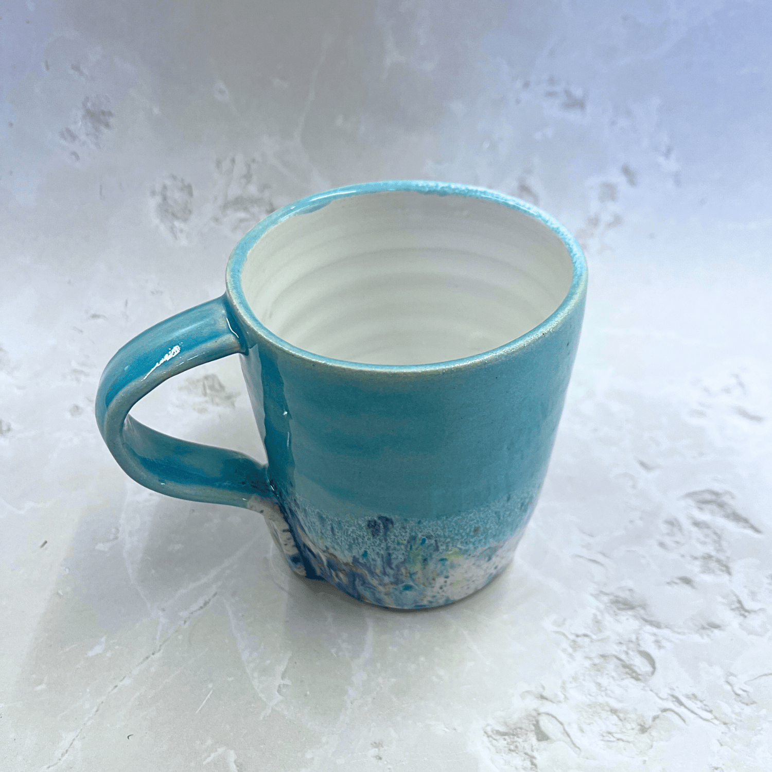 Ella Fletcher Designs Ceramic Standard Mug in Pale Blue Shoreline Design, pale blue top half with speckled bottom half inspired by the shoreline at East Lothian beaches