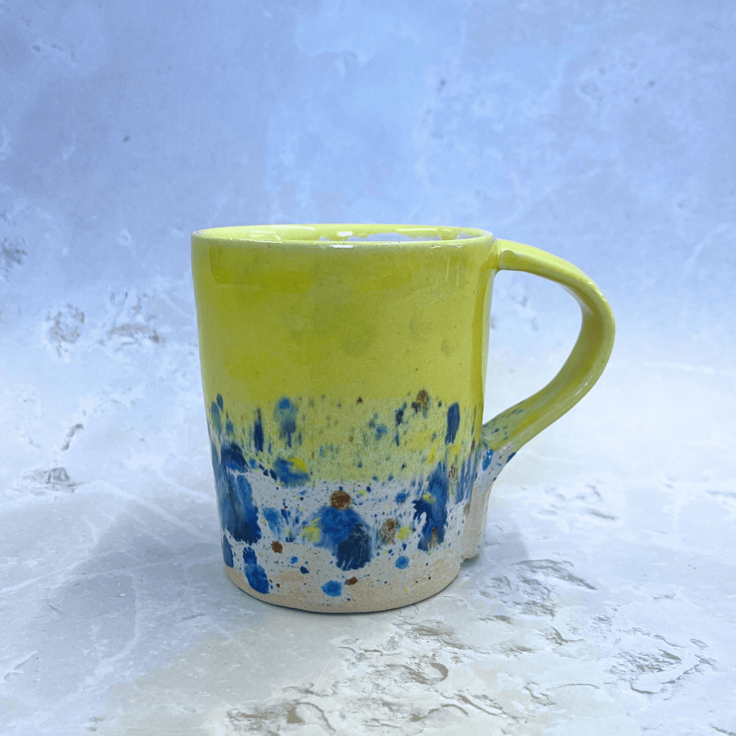 Ella Fletcher Designs Ceramic Handmade Yellow Shoreline Design Ceramic Mug, bright yellow top half with speckled bottom half inspired by the shoreline of East Lothian beaches