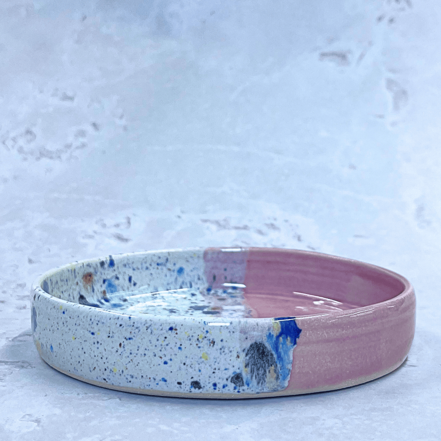 Ella Fletcher Designs Handmade Ceramics Trinket Dish in Pink Shoreline Design, small round dish with pink and multicolour speckles side view