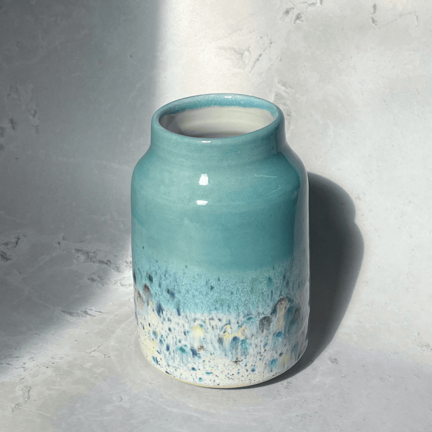 Ella Fletcher Designs Handmade Ceramic Vase in Pale Blue Shoreline Design - vase with solid pale blue top and multi-coloured speckles at the bottom
