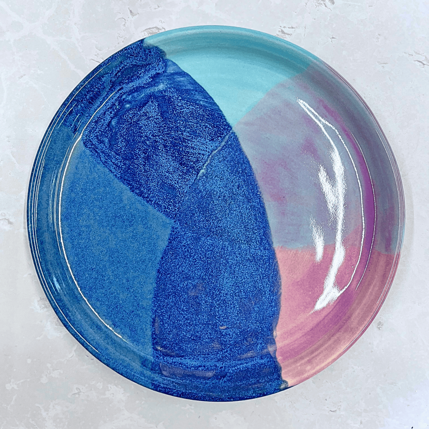 Ella Fletcher Designs Handmade Ceramic Dinner Plate in Scottish Sunrise Landscape, circular plate with layers of blues and pinks inspired by Scottish sunrises