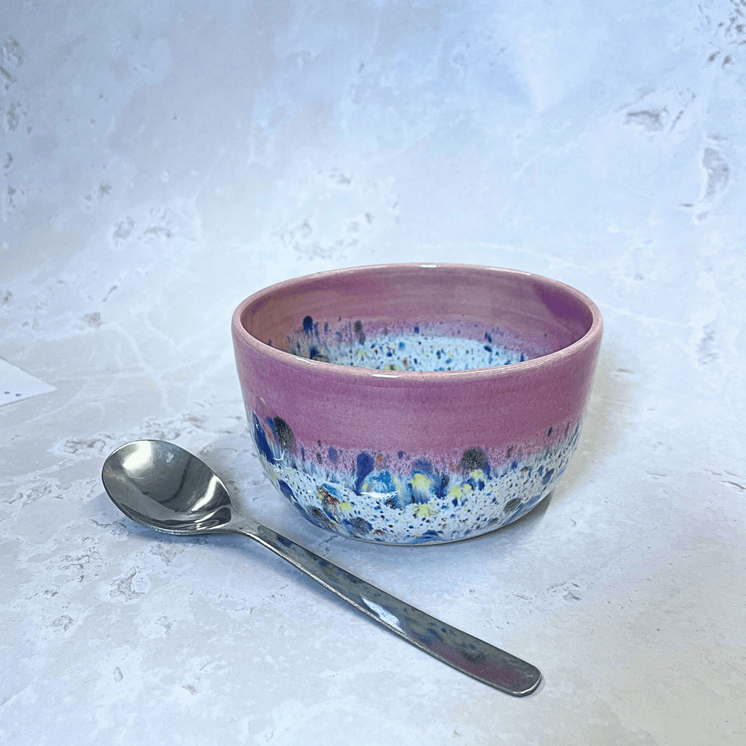 Ella Fletcher Designs Handmade Ceramics Small Bowl in Pink Shoreline design, round bowl with pink and multicolour speckles, featured with spoon for scale