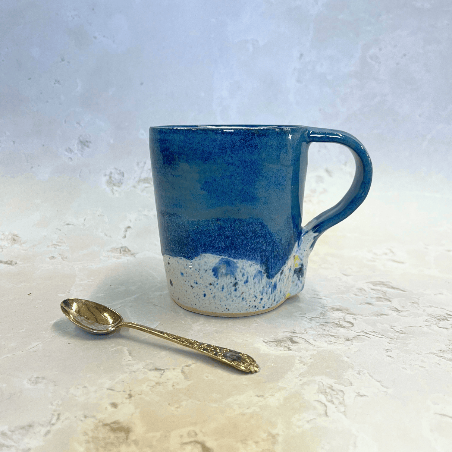 Ella Fletcher Designs Handmade Pottery Mug in Navy Shoreline Design, Navy top half of mug with speckled bottom inspired by the shoreline of East Lothian beaches