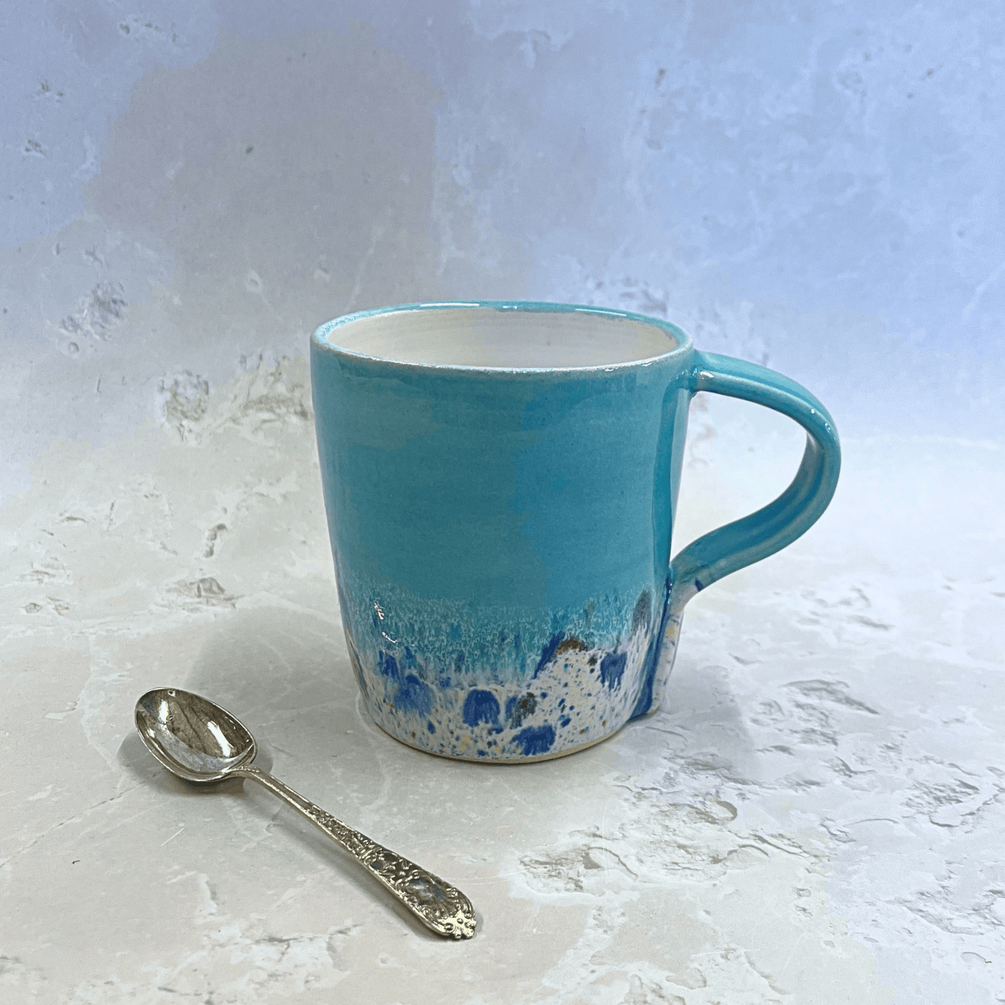 Ella Fletcher Designs Ceramic Standard Mug in Pale Blue Shoreline Design, pale blue top with speckled bottom half inspired by the shoreline at East Lothian beaches