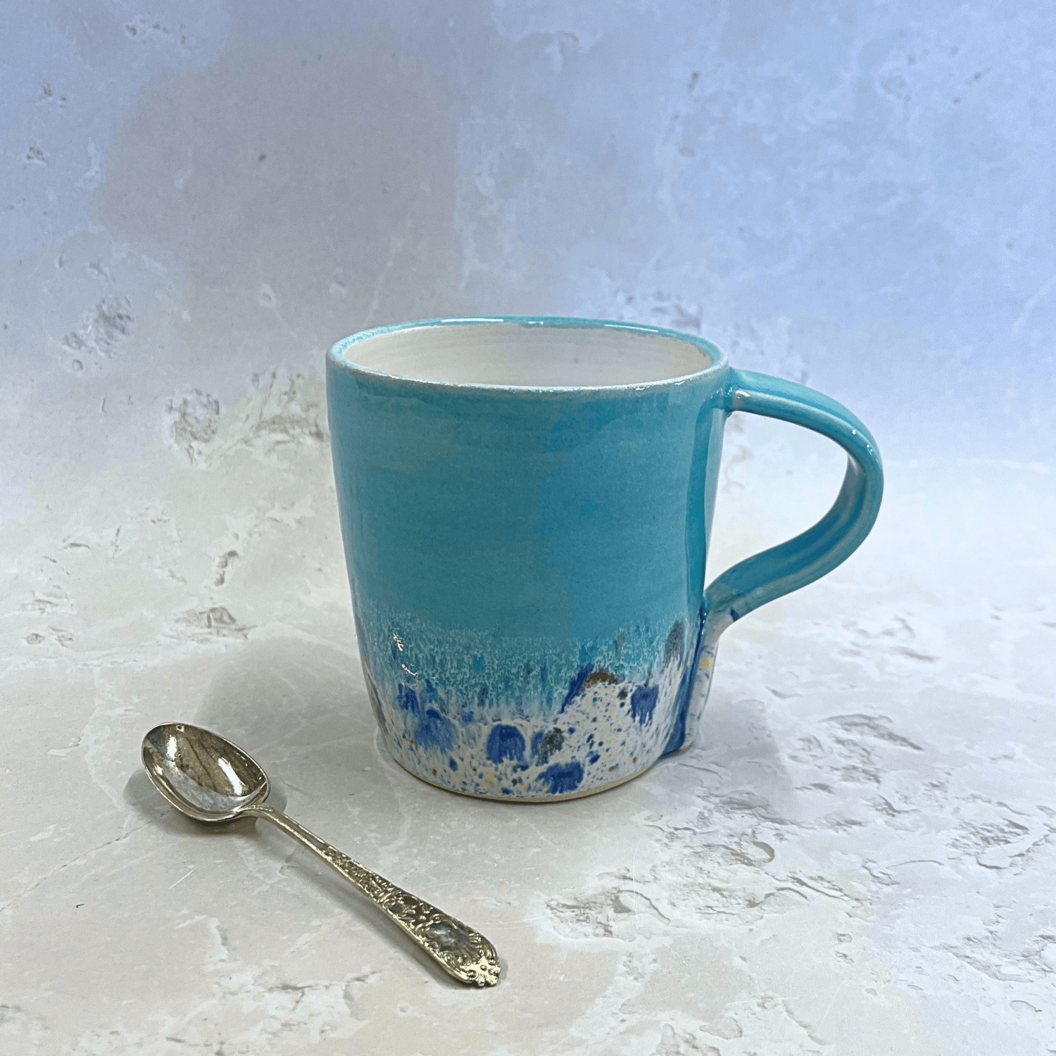 Ella Fletcher Designs Ceramic Standard Mug in Pale Blue Shoreline Design, pale blue top with speckled bottom half inspired by the shoreline at East Lothian beaches