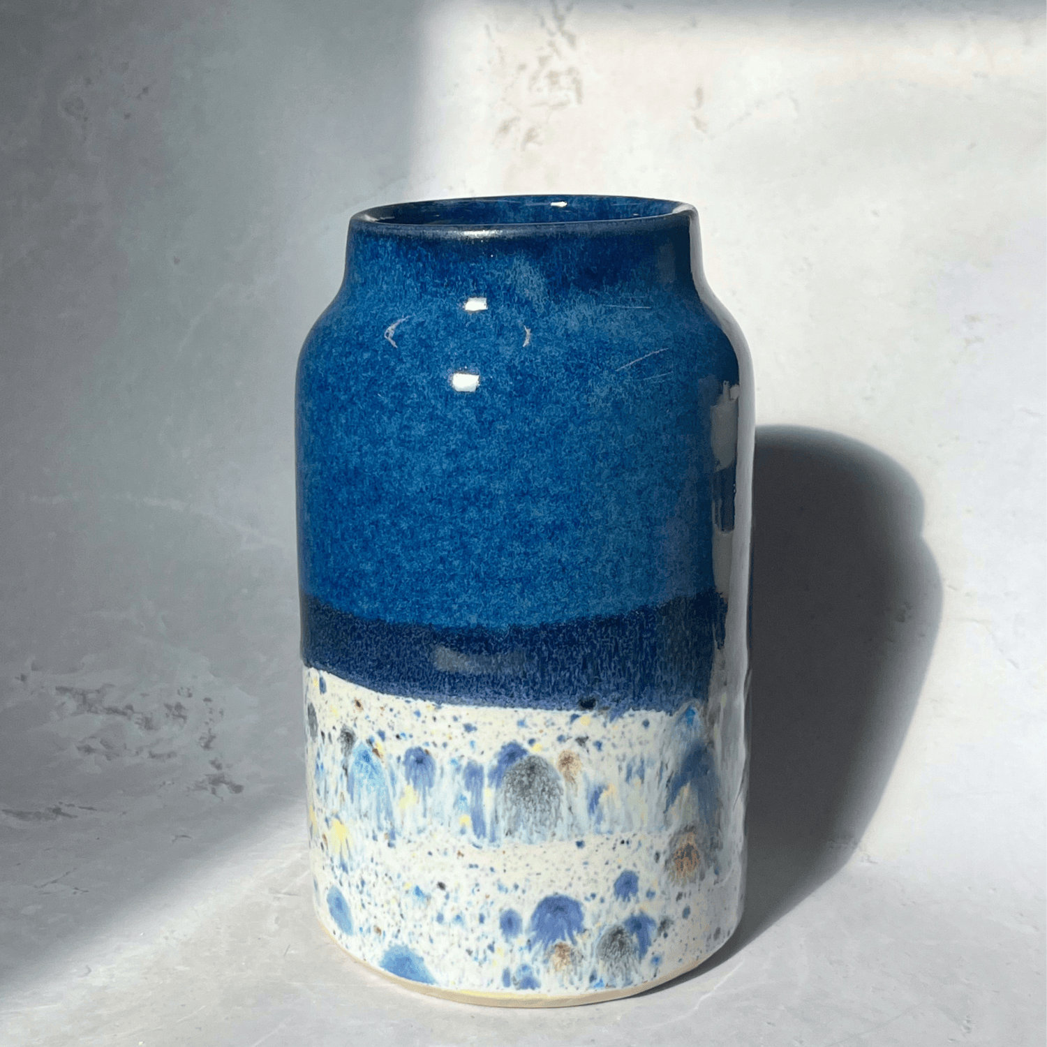 Ella Fletcher Designs Handmade UK Ceramic Vase in Navy Shoreline Design, navy upper half with multi-coloured speckles on bottom half