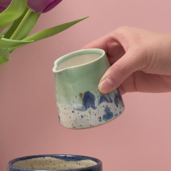Video of tiny jug pouring milk into a mug