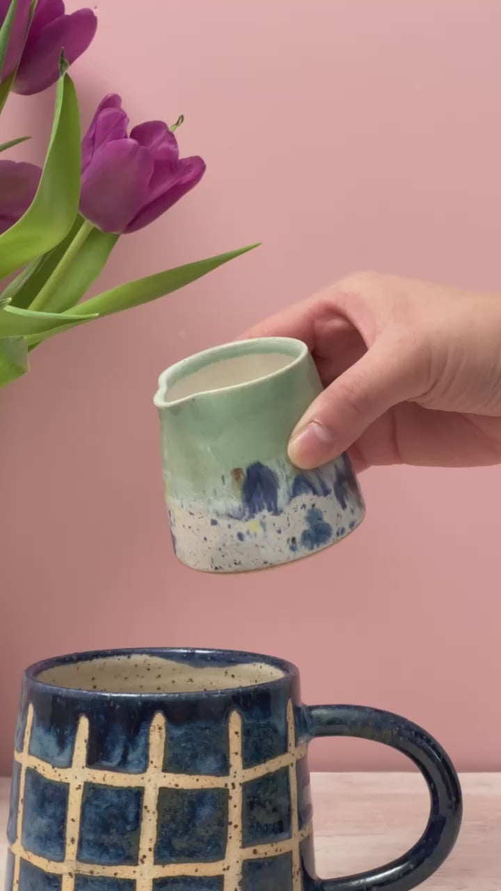 Video of tiny jug pouring milk into a mug