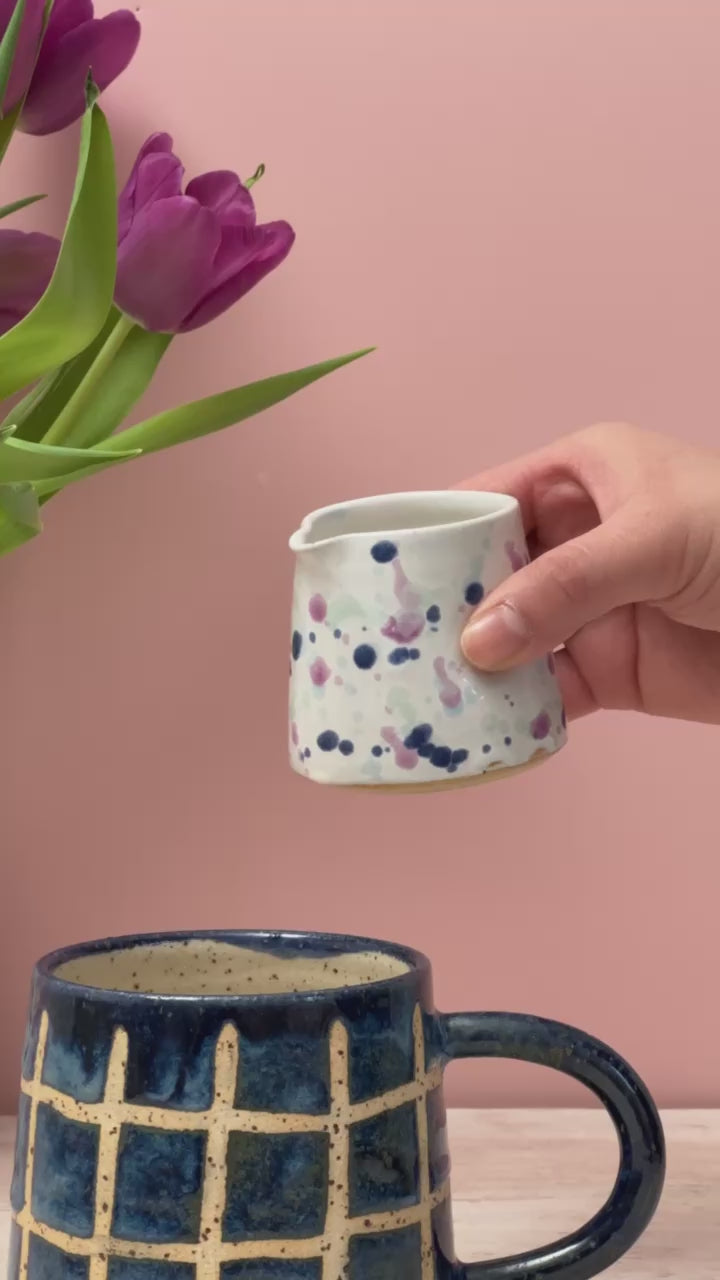 Video of tiny jug pouring milk into a mug