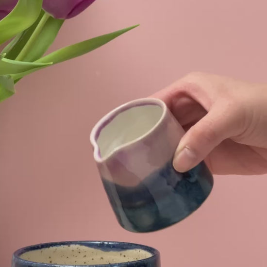 Video of tiny jug pouring milk into a mug