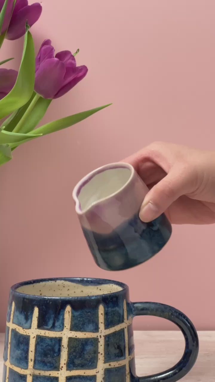 Video of tiny jug pouring milk into a mug