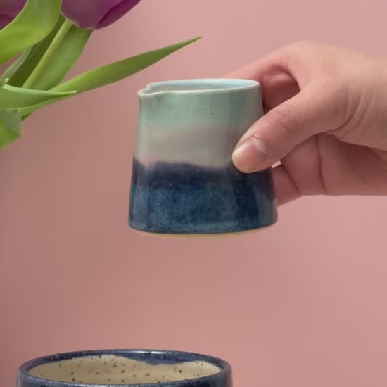 Video of tiny jug pouring milk into a mug